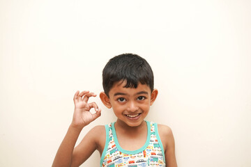a cute indian asian boy of 5 years with gorgeous eyes and jovial facial expression