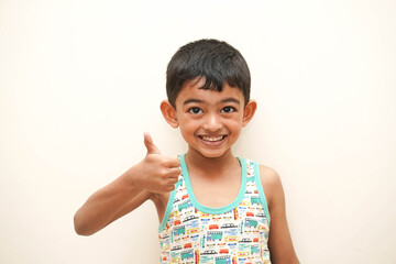 a cute indian asian boy of 5 years with gorgeous eyes and jovial facial expression