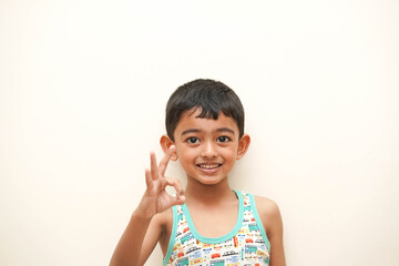 a cute indian asian boy of 5 years with gorgeous eyes and jovial facial expression