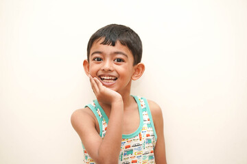 a cute indian asian boy of 5 years with gorgeous eyes and jovial facial expression
