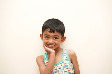a cute indian asian boy of 5 years with gorgeous eyes and jovial facial expression