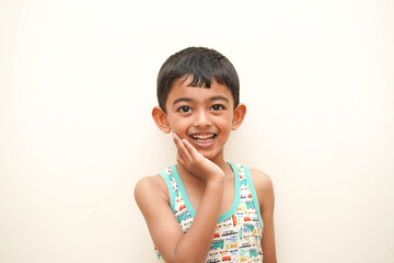 a cute indian asian boy of 5 years with gorgeous eyes and jovial facial expression