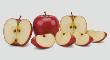 Red apples whole and sliced arranged on a white surface.