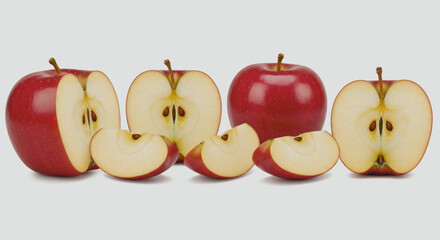 Red apples whole and sliced on a white background.