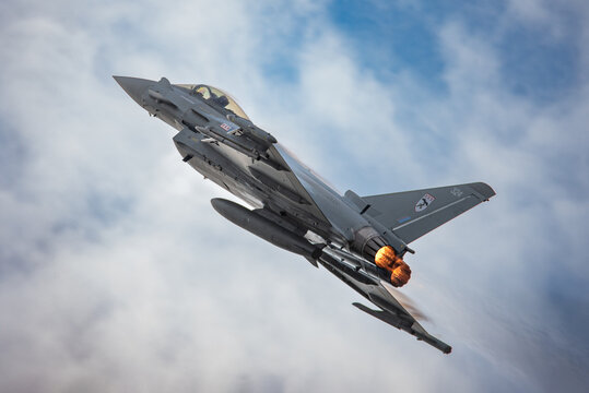 Old Buckenham, UK, July 27 2025: RAF Eurofighter Typhoon military fighter jet in flight on afterburners at the airshow