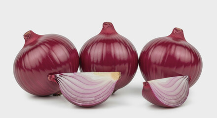 Three red onions and two onion wedges on a white surface.