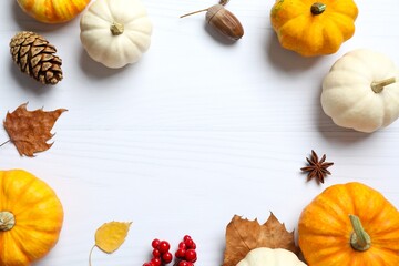 Top view of autumn composition with pumpkins on a white wooden background, top view. Harvest Festival, Thanksgiving and Halloween concept