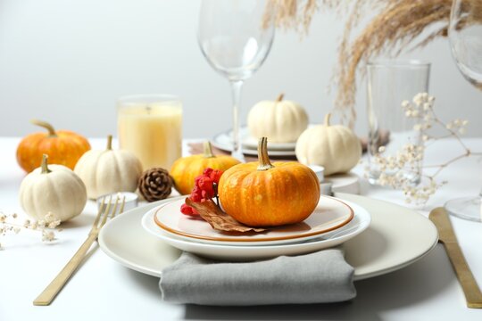 Festive holiday table setup. Top view with plates, cutlery and autumn decorations. Thanksgiving Day or Harvest festival