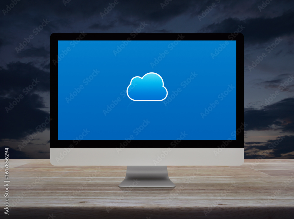 Poster cloud computing flat icon on modern computer monitor screen on wooden table over sunset sky, technol