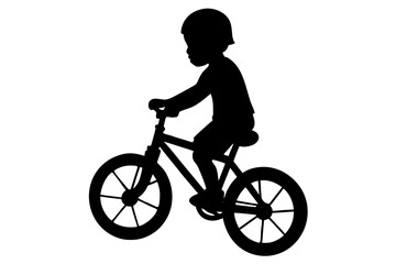 Obraz premium Silhouette of a child wearing a helmet riding a bicycle
