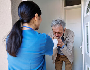 Doctor or nurse caregiver woman with senior man at home or nursing home, a caregiver standing on...