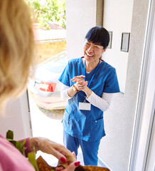 Doctor or nurse caregiver woman with senior woman at home or nursing home, a caregiver standing on...