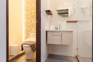 Modern bathroom with ryokan inspired japanese style featuring clean lines and minimalistic design to rest and relax in peaceful atmosphere with soft lighting and simple decor