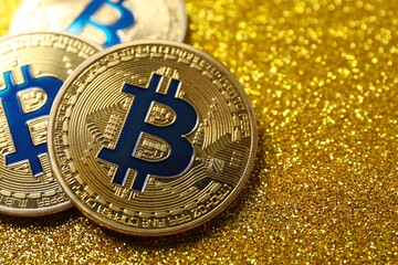 Bitcoin concept. Golden coins on shiny background
