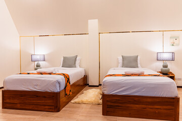 Japanese ryokan style bedroom with two wooden beds and soft lighting creating rest and relax...