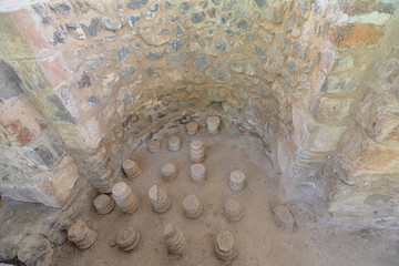 Hypocaust heating system with brick pilae supporting the floor in the roman bath ruins of Garni Archaeological Complex in Armenia, showing ancient roman engineering and architecture