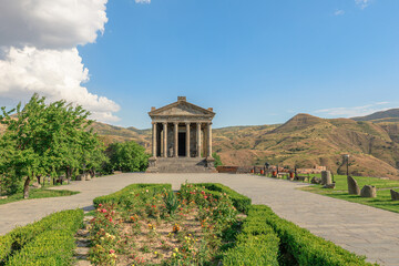 Garni Temple, showcasing stunning Greco-Roman architecture, rises majestically in the picturesque landscape of Kotayq Province, Armenia, under a bright blue sky