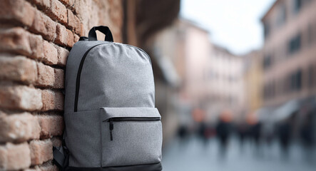 Gray backpack against a brick wall in a European city. Travel gear. Perfect for adventure, education, or urban lifestyle concepts. Space for copy.
