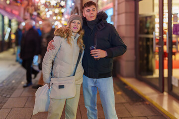 Mother and son posing at a Christmas market.