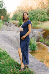 Pregnant Woman Standing Near Forest Stream Outdoors