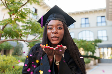 Graduate wearing mortarboard celebrates education success outdoors