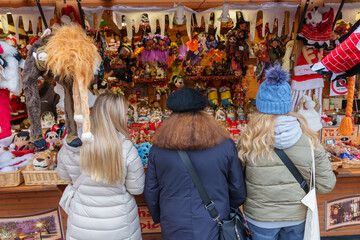 Women browsing a Christmas market stall in Strasbourg