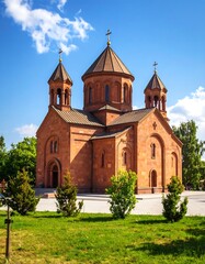 Orthodox church with green lawn and trees