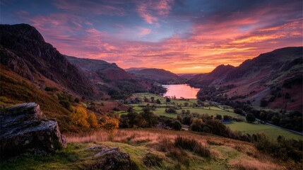 Orange and Pink Sunset Over a Valley Between Hills and Lake