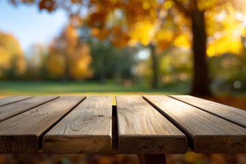 Wood planks form a tabletop blurring into a fall scene with colorful trees in the background