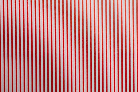 Abstract geometric, striped pattern. Seamless Christmas red background. Peppermint wrapping print. Cute caramel package texture. Xmas holiday diagonal lines. Red white striped background