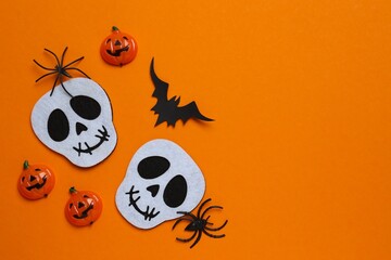 Halloween poscard. Skulls, bat, spider and confetti. Halloween festive background . Top view, space...