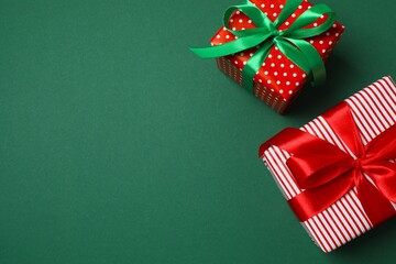 Elegant gift boxes decorated with ribbons neatly placed on a bright green background

