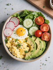 Avocado Egg Bowl. Soft scrambled eggs, avocado, cucumber, radish, lettuce, cherry tomatoes. Finish with cracked pepper and herbs
