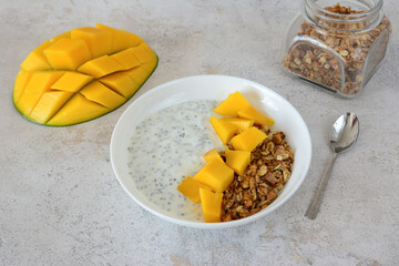 Healthy Mango Yogurt Bowl with Granola and chia seeds healthy snack