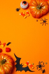 Happy Halloween holiday concept. Festive background design featuring decorative orange pumpkin,...