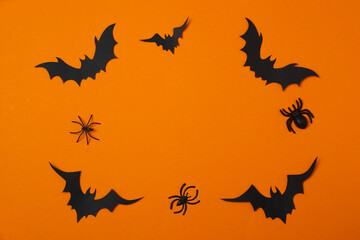 Top view of Halloween festive background design featuring black bats and spiders. Happy Halloween...