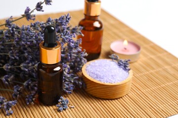 Beautiful spa composition with essential oil and lavender flowers in spa room - beauty treatment. Lavender essential oil still life