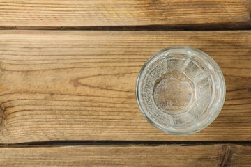 Transparent glass with water on a wooden table. Drinking clear water in the morning for health