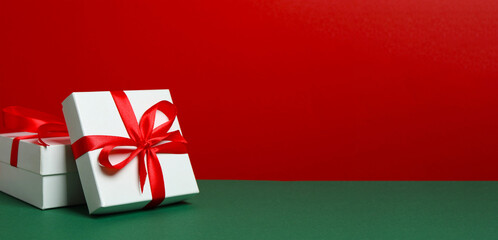 Beautiful gifts with ribbons on two-tone background. Perfect for festive, elegant holiday themes.