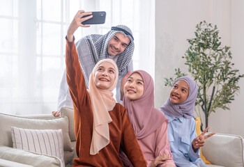 portrait bonding muslim family in traditional clothes,women wear hijab and a man wears kandora...