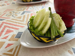 Cucumber and celery salad in a basket on the table