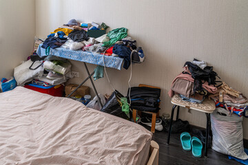 The mess and trash in the woman's bedroom, the scattered clothes and shoes, the dirt and dust.