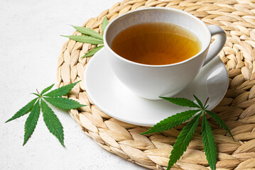 Hemp herbal tea and green hemp leaves