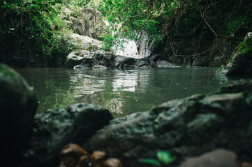 Tranquil Waterfall View Surrounded by Lush Greenery and Rocks