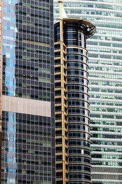 Architectural cylindrical design in geometric highrise cluster in Singapore financial district, Asia