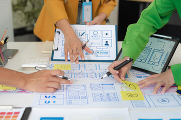 Creative digital development agency. developer team brainstorming on their project with laptop, smartphone and digital tablet.