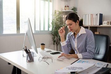 Office Syndrome: Stressed Woman at Desk with Headache