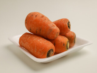 Baby carrots on white tray