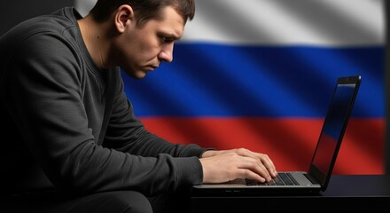 Man typing on a laptop with the Russian flag in the background, representing Russian technology, cybersecurity, or geopolitical themes.

