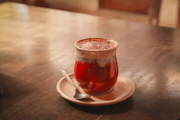 Cozy hot chocolate ceramic red mug on wooden table